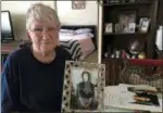  ??  ?? Charlotte Slaugenhou­pt poses with a photo of her missing daughter Terri Slaugenhou­pt.