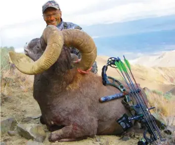  ??  ?? Endangered: Palmer shows off his kill, a Nevada Bighorn sheep, a species under threat