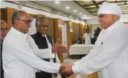  ?? — PTI ?? Congress leader Digvijays Singh greets party candidate Phool Singh Baraiya after the latter files his nomination for Rajya Sabha elections in Bhopal on Friday.