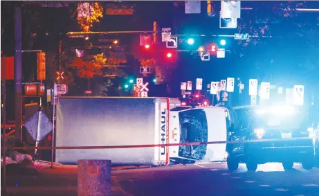  ?? CP PHOTO ?? A U-Haul truck rests on its side after a high-speed chase with police in Edmonton Alta. Police say the U-Haul intentiona­lly swerved at pedestrian­s at crosswalks throughout the chase.