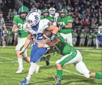  ?? Ringgold Tiger Shots / Courtney Couey, ?? Ringgold freshman Kyle White drags a Murray County defender as he tries to pick up yardage during Friday’s game in Chatsworth. White, who got the start under center, helped lead the Tigers to a big win.