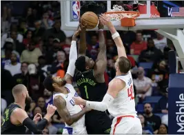  ?? MATTHEW HINTON — THE ASSOCIATED PRESS ?? The Pelicans' Zion Williamson puts up an inside shot between Clippers defenders Paul George and Ivica Zubac, right, during Friday's game at New Orleans.