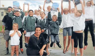  ?? Photo: ANDREA O’NEIL ?? Meeting of minds: Titahi Bay surf club’s trainee lifesavers, the Nippers, with co-ordinator Paul Mcvicar, left, and Porirua City councillor ’Ana Coffey. The Nippers will fundraise for new equipment by selling food at a meeting tonight for residents...