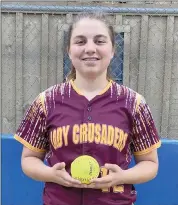  ?? Photo submitted ?? Lucy Klawuhn is shown with her home run ball after hitting a solo home run for the Lady Crusaders to lead off the bottom of the seventh inning of Wednesday’s game against Otto-Eldred.