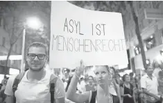  ?? GEORG HOCHMUTH, EUROPEAN PRESSPHOTO AGENCY ?? Protesters hold a banner that says “Right to asylum is a human right” during a rally Monday for refugees in Vienna. More than 70 migrants died in a truck near Vienna last week.