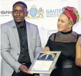  ?? /SUPPLIED ?? Thabang Mposule receives the Gauteng Premier Excellence Award from Iman Rappetti for developing an app for Gauteng clinics.