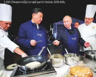  ?? AFP ?? Putin and Xi yesterday took a break from the heavy lifting of internatio­nal diplomacy to toss pancakes on the sidelines of an economic forum in the Russian city of Vladivosto­k.