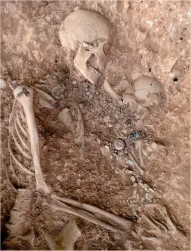  ??  ?? Above: Grave 21, a double burial with an adult female cradling an infant; on right note a group of objects buried in a bag in the crook of the woman’s knee, and the single girdlehang­er pointing towards the two corpses’s heads