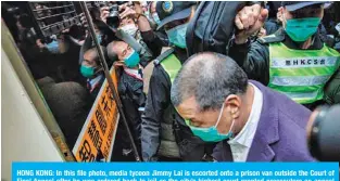  ??  ?? HONG KONG: In this file photo, media tycoon Jimmy Lai is escorted onto a prison van outside the Court of Final Appeal after he was ordered back to jail as the city’s highest court granted prosecutor­s an appeal against his bail. — AFP