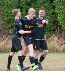  ??  ?? Avonmore’s Oisin McGraynor is congratula­ted by his colleagues after scoring one of his three goals in the game.