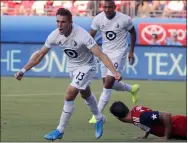  ?? TONY GUTIERREZ — THE ASSOCIATED PRESS ?? Minnesota United’s Ethan Finlay (13) and Angelo Rodriguez, rear left, celebrate Finlay’s goal against FC Dallas during a 2019 match.