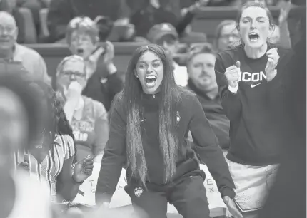  ?? STEPHEN DUNN/AP ?? Connecticu­t’s Evina Westbrook, center, cheers for her team from the bench during a game against California on Nov. 10 in Storrs, Conn. Westbrook, a transfer student, was denied immediate eligibilit­y by the NCAA to play this season. UConn is appealing the decision.