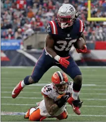  ?? MATT STONE — BOSTON HERALD ?? Sione Takitaki of the Cleveland Browns tries to tackle Patriots running back Rhamondre Stevenson during the third quarter of a game at Gillette Stadium on Nov. 14, 2021 in Foxboro. Now they are teammates.