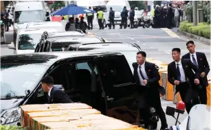  ?? (Tyrone Siu/Reuters) ?? NORTH KOREAN security personnel run alongside a motorcade in Singapore yesterday, believed to be carrying North Korea’s leader Kim Jong-un.