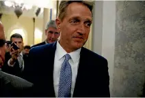  ?? PHOTO: REUTERS ?? US Republican Senator Jeff Flake walks past journalist­s on Capitol Hill in Washington after announcing he will not run for re-election.