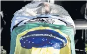  ?? AFP ?? Pele’s coffin is draped in the flags of Brazil and Santos.