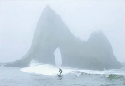  ?? Photograph­s by Allen J. Schaben Los Angeles Times ?? MARK MASSARA, a Surfrider Foundation consultant, rides a wave at Shark’s Tooth Rock on Martins Beach near Half Moon Bay.