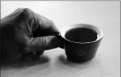  ?? ASSOCIATED PRESS ?? KLATCH COFFEE OWNER BO THIARA HOLDS A CUP OF ELIDA NATURAL GEISHA COFFEE at his shop in San Francisco. The California cafe is brewing up what it calls the world’s most expensive coffee — at $75 a cup. 11 people killed in reported gun attack at bar in Brazil