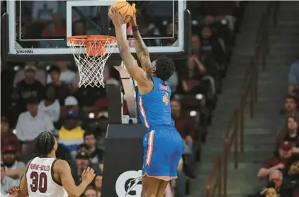  ?? ARTIE WALKER JR./AP PHOTOS ?? Florida forward Tyrese Samuel dunks as South Carolina’s Collin Murray-Boyles can only spectate Saturday in Columbia.