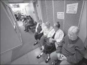  ?? Arkansas Democrat-Gazette/MITCHELL PE MASILUN ?? Vickie Taylor (from right), Ruby Coosenberr­y, Helen Brummett and Sandra Hyatt wait in line Monday before the start of early voting at the Laman Library in North Little Rock. The women arrived more than two hours early to get the first four spots in line.