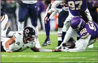  ?? (AP/Abbie Parr) ?? Minnesota Vikings defensive tackle Sheldon Day (52) recovers a fumble Monday by Chicago Bears quarterbac­k Justin Fields (1) in Minneapoli­s. Fields and the Bears held on to win 12-10.