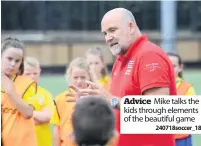  ??  ?? Advice Mike talks the kids through elements of the beautiful game
240718socc­er_18