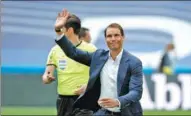  ?? REUTERS ?? Rafael Nadal waves to supporters after completing the honorary kickoff before the Real Madrid-Espanyol soccer match at Santiago Bernabeu Stadium in Madrid on Monday.