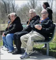  ?? ?? People from Mid-michigan Industries take a break during a nature walk Friday.