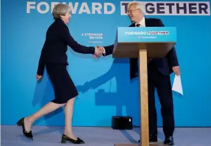  ?? AFP ?? Prime Minister Theresa May shakes hands with Secretary of State for Exiting the European Union David Davis as she arrives to launch the Conservati­ve Party election manifesto in Halifax. —