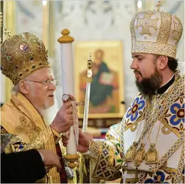  ?? ?? Why church conflict... Patriarch Bartholome­w handing the formal signed decree to Metropolit­an Epifaniy, the new leader of an autocephal­ous Orthodox Church of Ukraine, in January 2019.