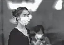  ?? REUTERS PHOTO ?? Fear of the coronaviru­s is prompting people around the world, such as this woman in Thailand, to wear face masks. Sales of face masks are brisk in St. John’s.