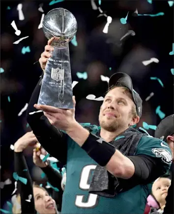  ?? Timothy A. Clary/Getty Images ?? Attention NFL fans: These are not your 2017 Philadelph­ia Eagles although the presence of Nick Foles back under center might make it seem as if they are.