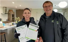  ??  ?? A massive clean-up task to hand, but Chris and Anne-Marie Allen had time to make PM Jacinda Ardern a cup of tea as she arrived by helicopter to inspect damage in the province.