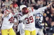  ?? ASSOCIATED PRESS ?? USC’s Matt Boermeeste­r (right) celebrates after kicking the winning 46-yard field goal on the last play of the game.