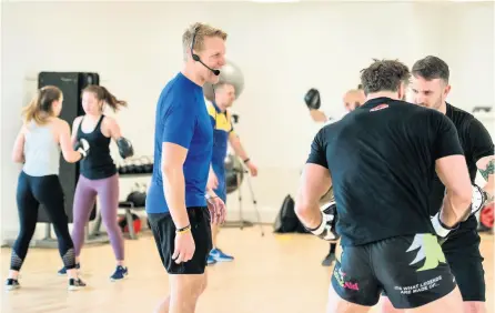  ??  ?? Rugby World Cup winner and former England captain Lewis Moody, centre, trying out a fitness session at the £3.5million Team Bath Gym and Fitness Centre at the University of Bath