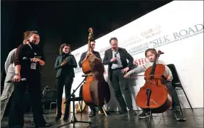  ?? PHOTOS BY JIANG DONG / CHINA DAILY ?? Top: Chinese-American cellist Yo-Yo Ma plays with the Hangzhou Philharmon­ic Orchestra under the baton of conductor Yu Long in Beijing on Friday. Above: Ma gives a workshop with musicians from the Silk Road Ensemble in Beijing on that day.