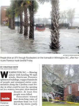  ?? AP PHOTO/CHUCK BURTON AP PHOTO/CHUCK BURTON ?? People drive an ATV through floodwater­s on the riverwalk in Wilmington, N.C., after Hurricane Florence made landfall Friday. A fallen tree is shown after it crashed through the home where a woman and her baby were killed in Wilmington, N.C., after Florence made landfall Friday.