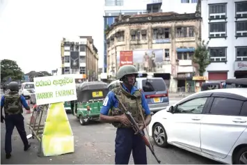  ??  ?? Sri Lankan soldiers man their positions at a checkpoint in Colombo, Sri Lanka. Many holidaymak­ers got the first plane out of Colombo after the blasts, raising fears for a tourism industry that had managed to move on from the shadows of a decades-long civil war. — AFP photo