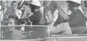  ?? JIM ALTGENS, / THE ASSOCIATED PRESS ?? President John F. Kennedy waves from his car on Nov. 22, 1963, in Dallas just before his assassinat­ion.