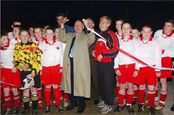  ??  ?? Minister Dermor Ahern cuts the tape at the official opening of Rock Celtic’s floodlight­s.