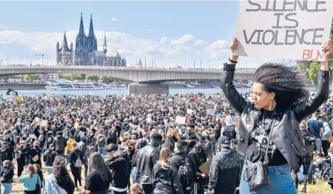  ?? MEISSNER/AP 2020 MARTIN ?? Thousands of people demonstrat­e June 6 in Cologne, Germany, to protest against systemic racism and the killing of George Floyd.