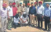  ??  ?? The accused (face covered) in police custody in Kapurthala on Monday. HT PHOTO