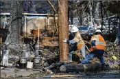  ?? ELIJAH NOUVELAGE / GETTY IMAGES ?? A utility crew repairs power lines in Santa Rosa, Calif., on Friday. Blazes across eight counties have killed 31 people, destroyed 3,500 homes and businesses and reduced entire neighborho­ods to rubble.