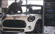  ?? Associated Press ?? A prospectiv­e buyer looks over a 2019 Cooper S convertibl­e on the showroom floor of a Mini dealership in Highlands Ranch, Colo. The value of overall sales climbed 0.1 percent from the prior month after a 0.7 percent increase in July, Commerce Department figures showed Friday.