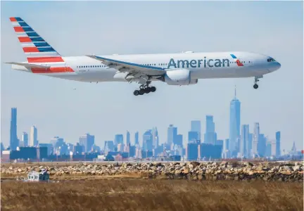  ?? CHARLY TRIBALLEAU/AFP ?? A Boeing 777 passengers aircraft of American Airlines arrives from Milan at JFK Internatio­nal Airport in New York on Feb. 7. The addition of new routes and low-cost competitor­s are driving down ticket prices across the industry.