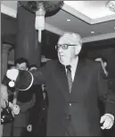  ?? PROVIDED TO CHINA DAILY; PHOTO ?? Top: Kissinger plays table tennis during a break from negotiatin­g the text of the Shanghai Communique during his October 1971 visit to Beijing.
Above: Kissinger waves a table tennis bat at the reception of the Chinese People’s Associatio­n for Friendship with Foreign Countries on March 18, 2001.