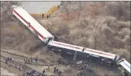  ?? Mark Lennihan / Associated Press ?? Emergency rescue personnel work the scene of a Metro-North passenger train derailment in Spuyten Duyvil in the Bronx, N.Y., on Dec. 1, 2013.