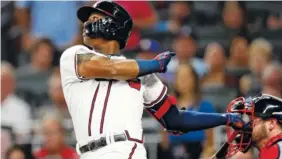  ?? AP PHOTO/JOHN BAZEMORE ?? The Atlanta Braves’ Ronald Acuna Jr. follows through on a two-run base hit in the second inning Friday against the Washington Nationals in Atlanta. The Braves won 10-5.