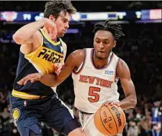  ?? Sarah Stier / Getty Images ?? Immanuel Quickley dribbles past Indiana’s T.J. Mcconnell in the Knicks’ 92-84 win at Madison Square Garden Monday.