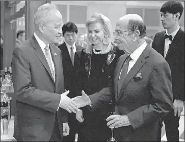  ?? Chen Mengtong China News Service ?? CHINA’S ambassador to the United States, Cui Tiankai, left, shakes hands with U.S. Commerce Secretary Wilbur Ross at a reception in February at the Chinese Embassy in Washington.